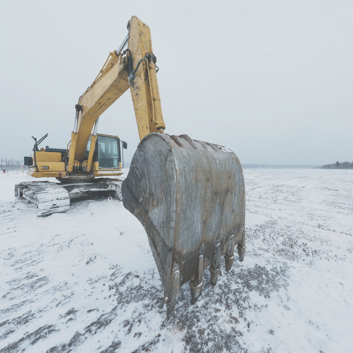 construction equipment in snow to demonstrate winter construction safety